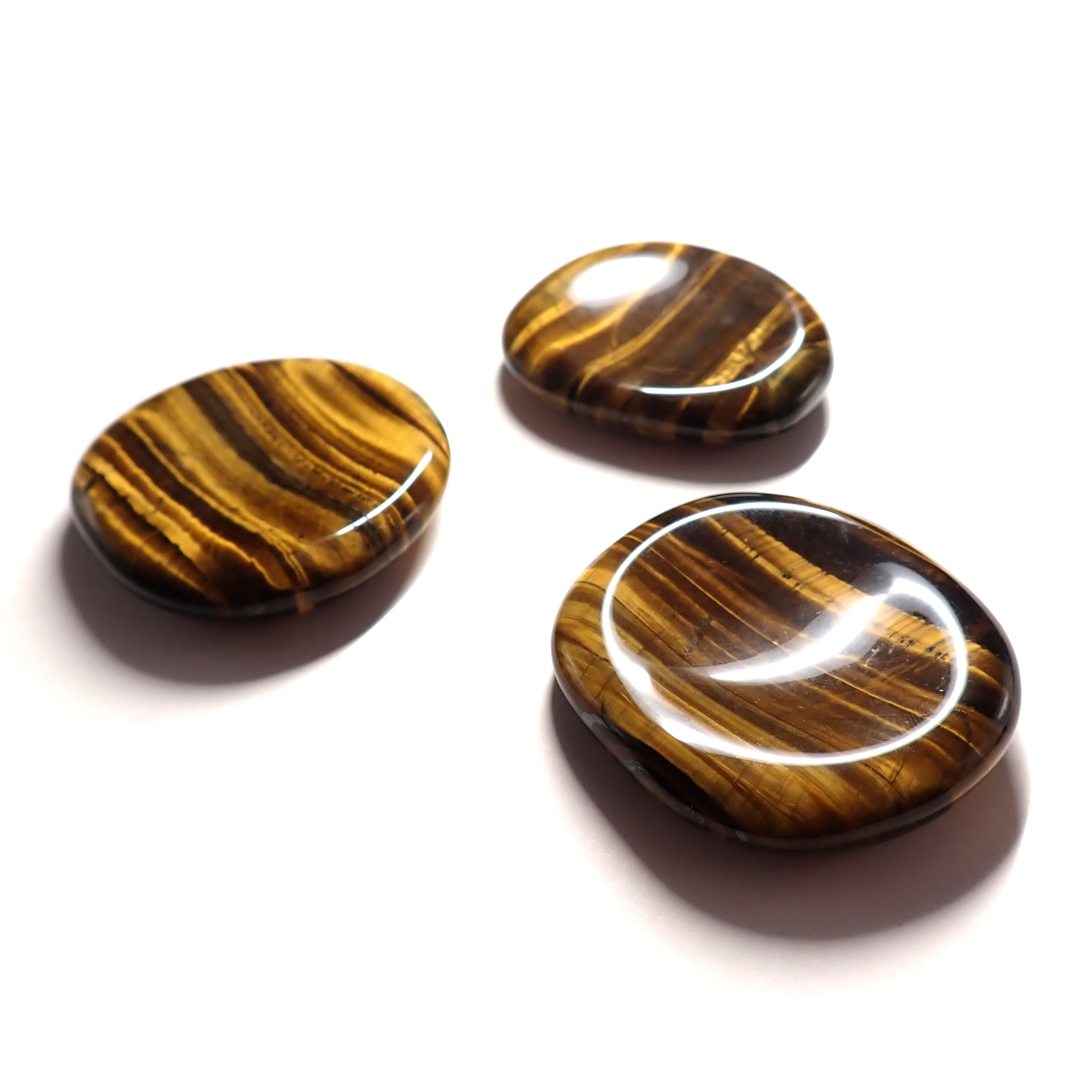 Photo de trois pierres pouce/worry stone en Oeil de Tigre